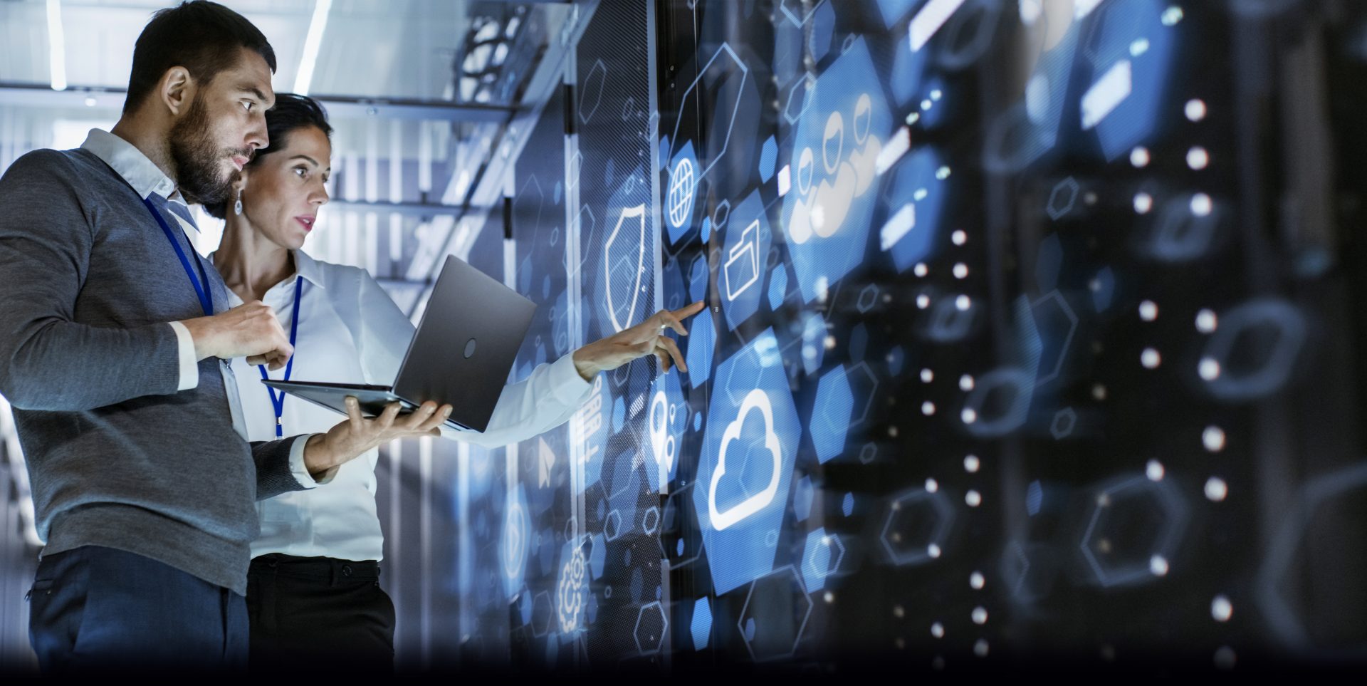 Two people working in a server room