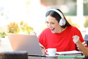Female on computer with headphones